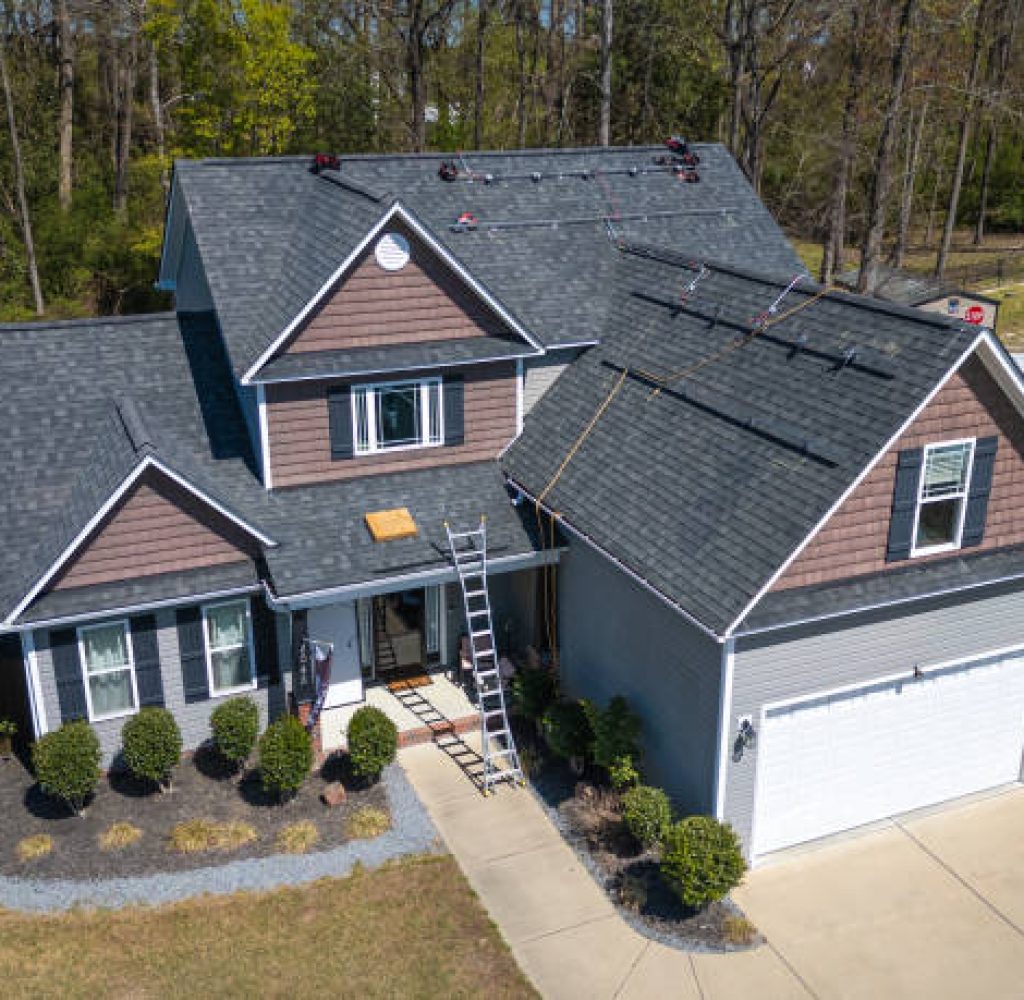 istockphoto-2159416425-612×612 (1) Roofer installing shingles on Caldwell County, TX residential roof