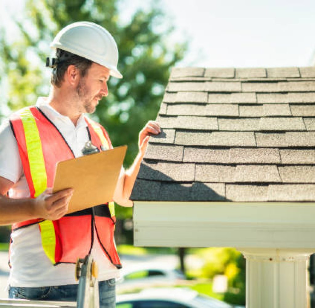 Roof inspector in Austin TX checking shingles for damage professionally
